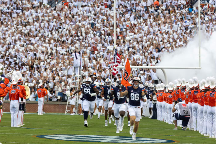 Luke Deal and Jalil Irvin lead the Auburn football team out on the field against Mercer.